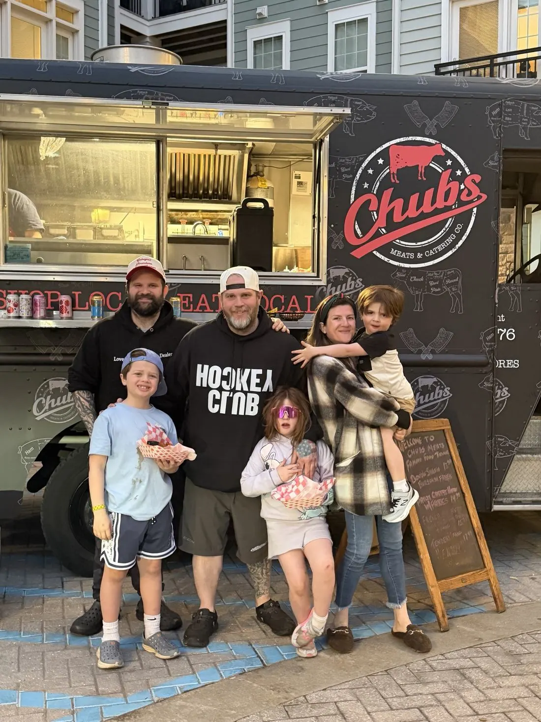 The Chubs crew and their families in front of the food truck at an event